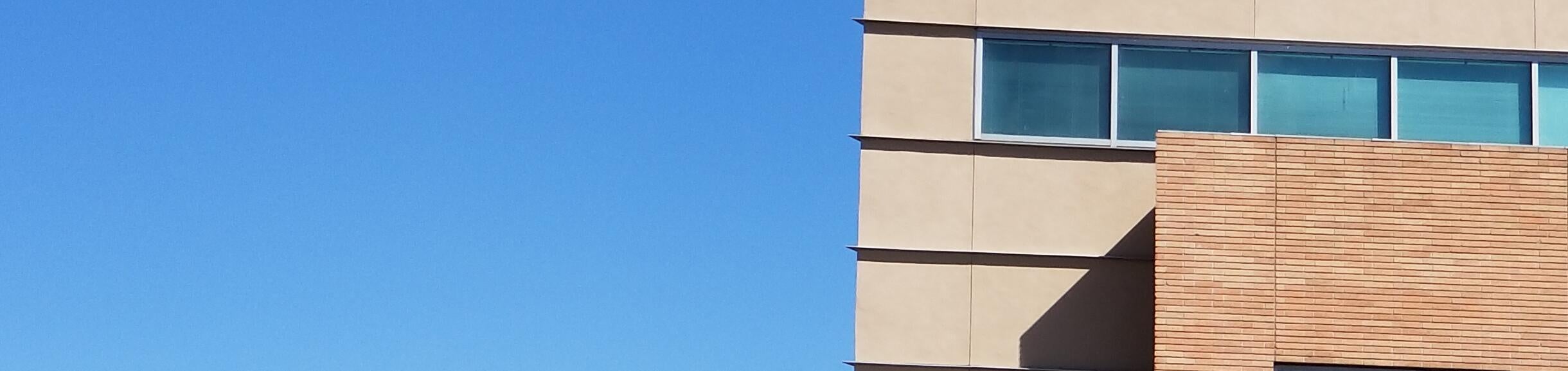 photo of Skye Hall against mountain and sky backdrop